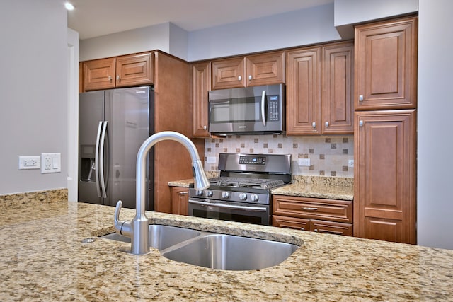 7420 W Lawrence Ave Unit 402, Harwood Heights, IL 60706 - kitchen with stainless steel appliances, light stone countertops, a sink, decorative backsplash, and brown cabinets