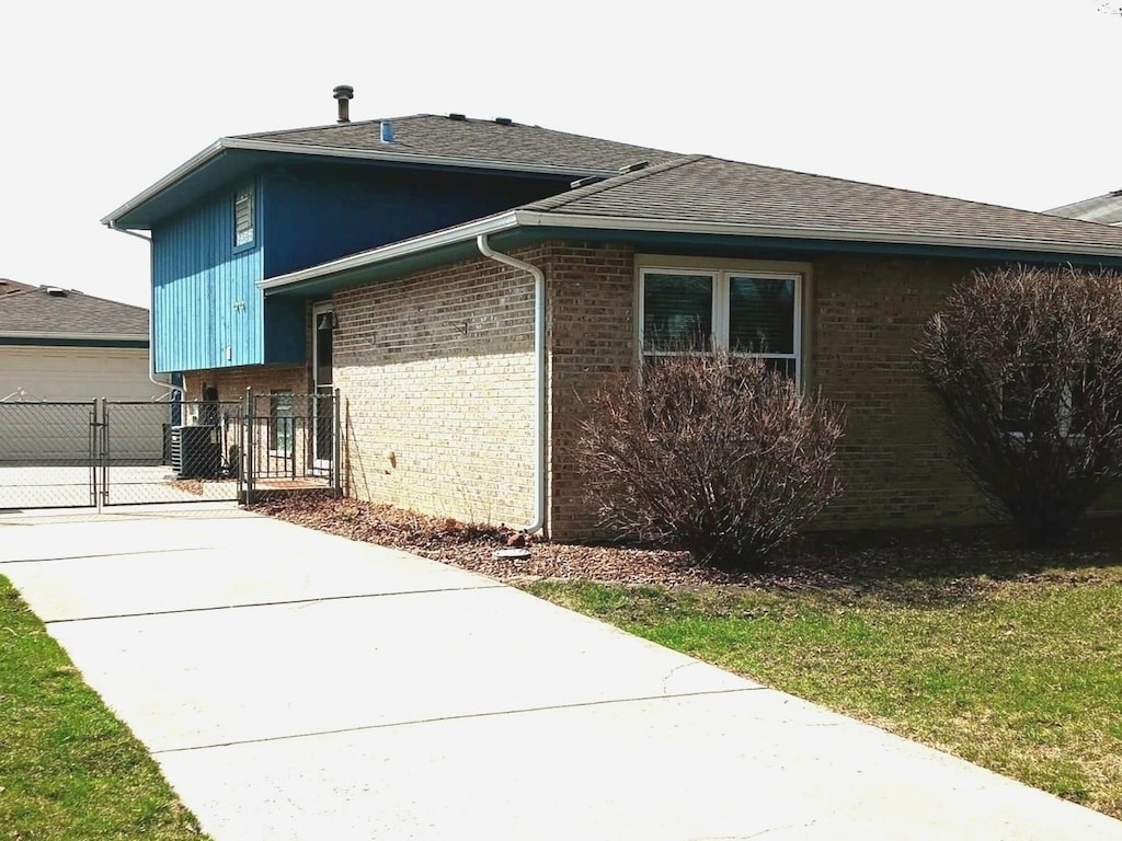 4419 141st Pl, Crestwood, IL 60418 - view of side of property featuring brick siding, a gate, a garage, and fence