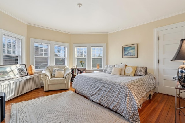 4923 S Greenwood Ave, Chicago, IL 60615 - bedroom featuring radiator heating unit, wood finished floors, and crown molding