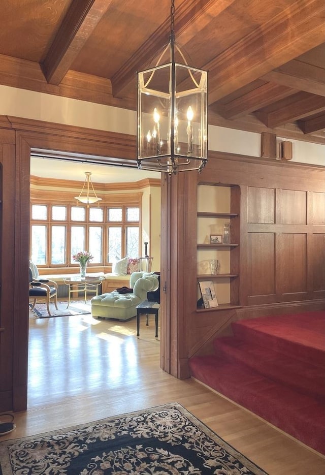 4923 S Greenwood Ave, Chicago, IL 60615 - detailed view of wood finished floors, a chandelier, ornamental molding, and a wooden ceiling with exposed beams