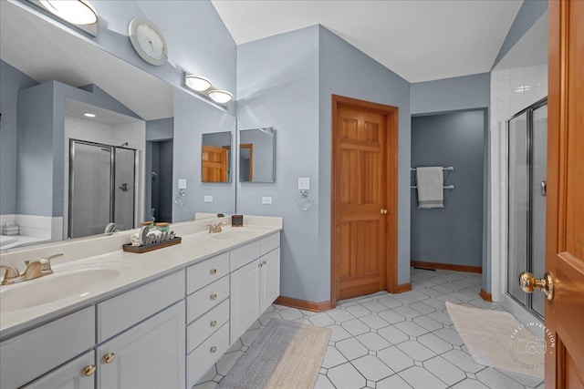 full bathroom with a sink, double vanity, and a stall shower