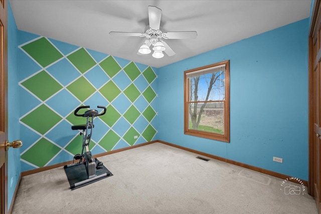 workout area with baseboards, carpet flooring, a ceiling fan, an accent wall, and visible vents