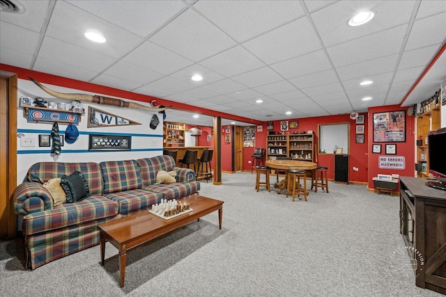 living room with a paneled ceiling, recessed lighting, carpet floors, visible vents, and a dry bar