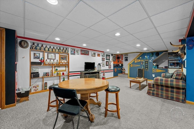 carpeted dining space with a paneled ceiling, baseboards, and recessed lighting