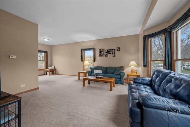 carpeted living room with a healthy amount of sunlight and baseboards