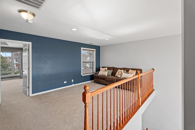 2366 Georgetown Cir, Aurora, IL 60503 - living area featuring baseboards, carpet flooring, visible vents, and a healthy amount of sunlight