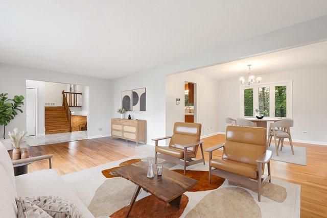 407 Brad Ct, Naperville, IL 60565 - living area featuring stairs, light wood finished floors, baseboards, and a chandelier