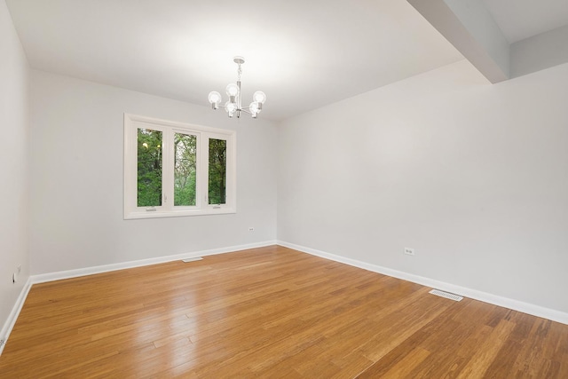 407 Brad Ct, Naperville, IL 60565 - unfurnished room with a chandelier, baseboards, and light wood-type flooring