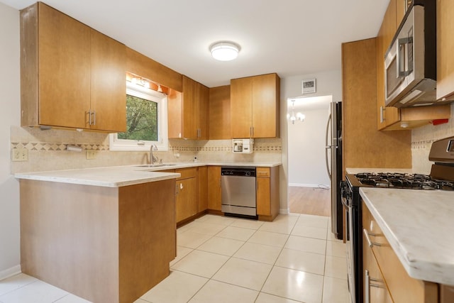 407 Brad Ct, Naperville, IL 60565 - kitchen with appliances with stainless steel finishes, a sink, decorative backsplash, light countertops, and light tile patterned floors