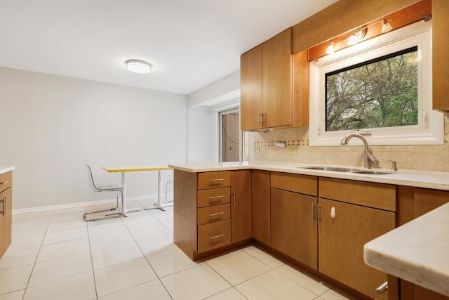 407 Brad Ct, Naperville, IL 60565 - kitchen featuring a sink, light countertops, and brown cabinetry
