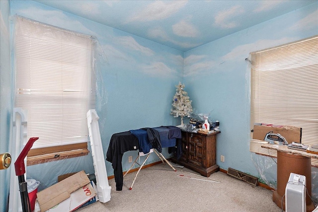 carpeted bedroom featuring baseboards