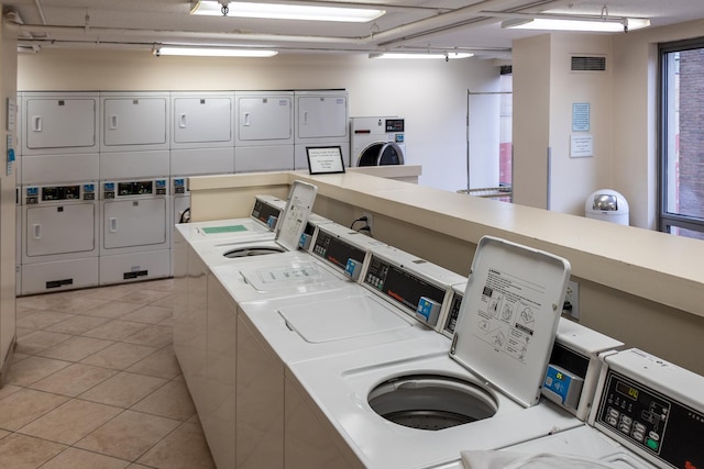 440 N Wabash St Unit 1807, Chicago, IL 60611 - shared laundry area with visible vents, stacked washer / dryer, washer and dryer, and light tile patterned floors
