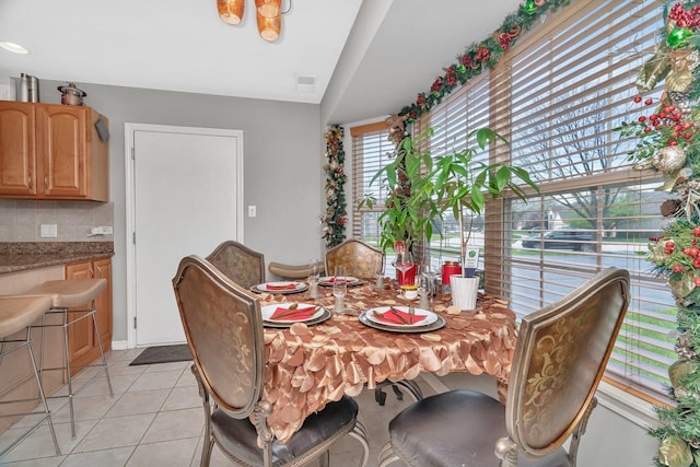 dining space with visible vents and light tile patterned floors