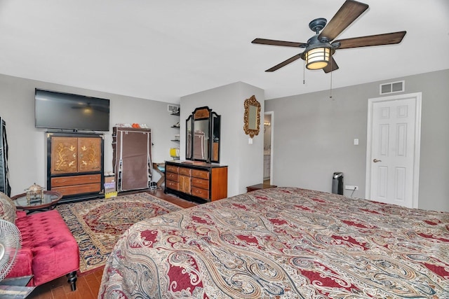 bedroom featuring visible vents, wood finished floors, and ceiling fan
