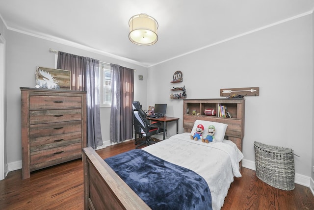 bedroom featuring baseboards, crown molding, and wood finished floors