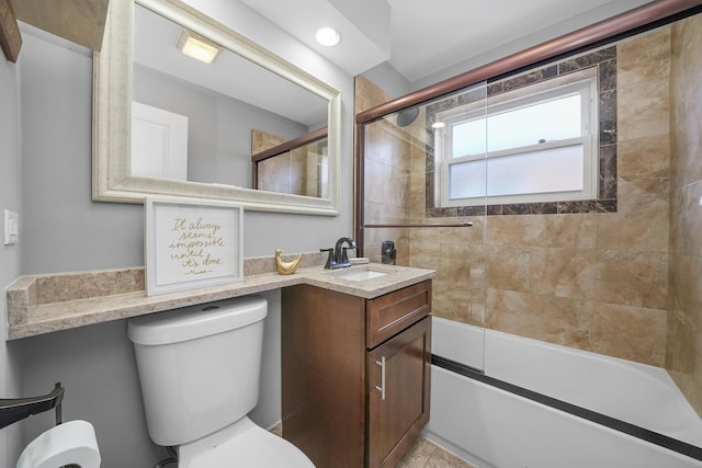 bathroom featuring toilet, shower / bath combination with glass door, and vanity
