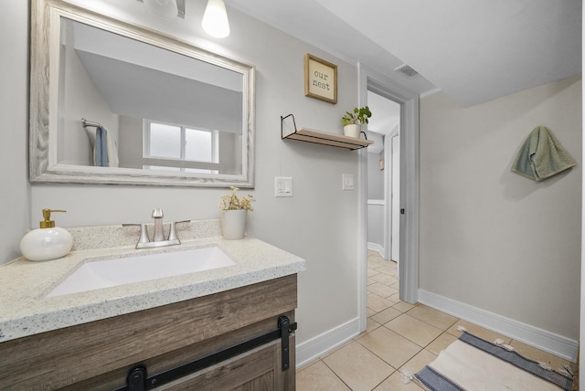 bathroom with tile patterned floors, vanity, baseboards, and visible vents