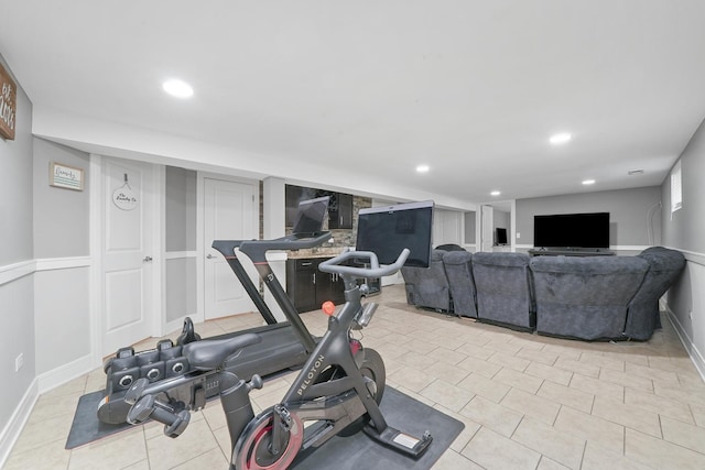 exercise room featuring baseboards, recessed lighting, and light tile patterned floors