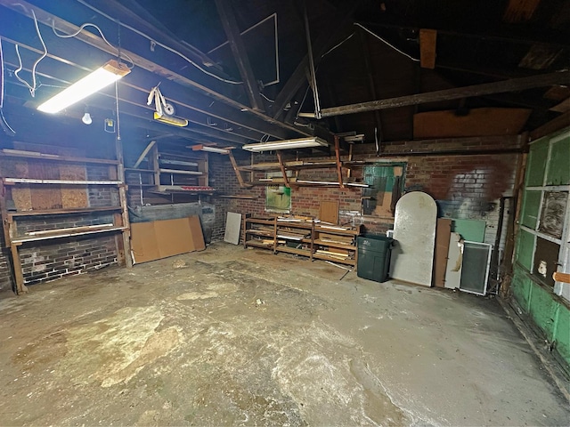 below grade area featuring a workshop area and brick wall