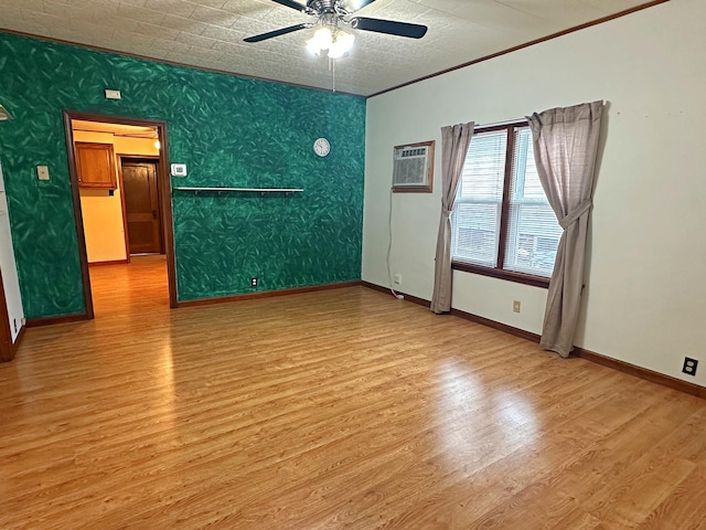 unfurnished room featuring baseboards, a wall mounted AC, wood finished floors, and a ceiling fan