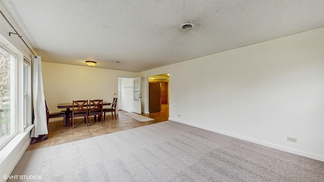 dining area featuring baseboards, visible vents, and carpet