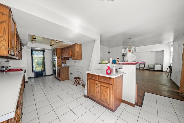 3917 Sunset Ave, Markham, IL 60428 - kitchen featuring double oven, brown cabinetry, light countertops, and open floor plan