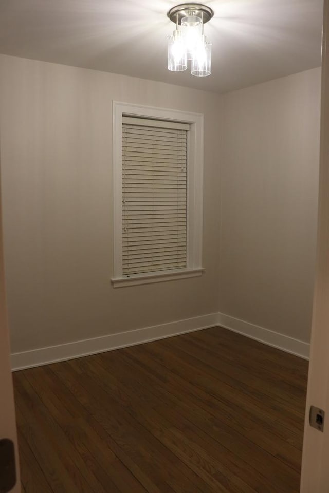 3418 N Nordica Ave, Chicago, IL 60634 - empty room with baseboards, an inviting chandelier, and dark wood-style flooring