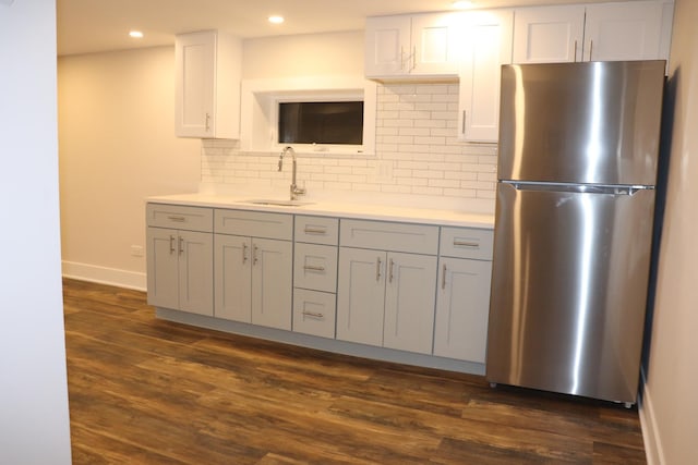 3418 N Nordica Ave, Chicago, IL 60634 - kitchen featuring light countertops, backsplash, a sink, freestanding refrigerator, and dark wood-type flooring