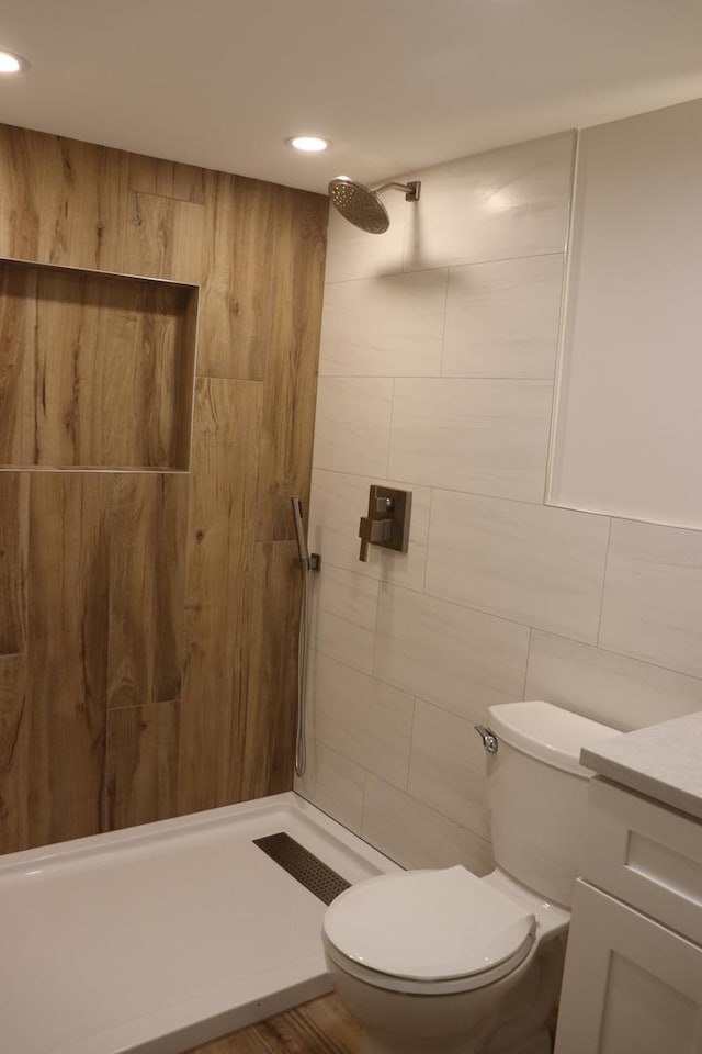 3418 N Nordica Ave, Chicago, IL 60634 - bathroom featuring tile walls, toilet, recessed lighting, vanity, and tiled shower