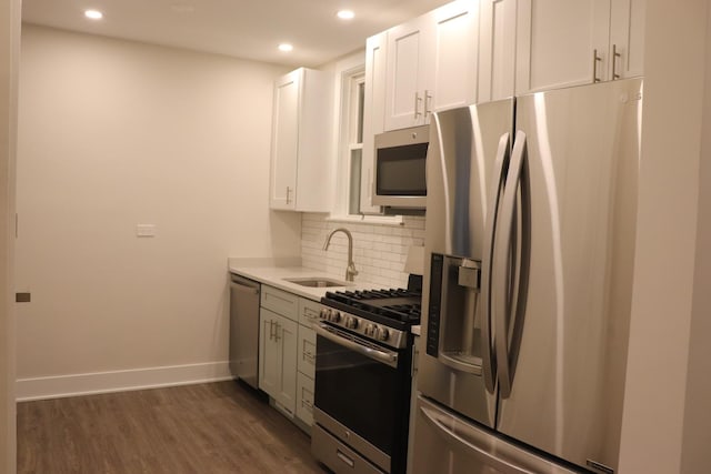 3418 N Nordica Ave, Chicago, IL 60634 - kitchen featuring a sink, tasteful backsplash, appliances with stainless steel finishes, baseboards, and dark wood-type flooring