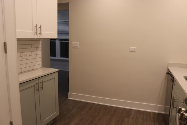3418 N Nordica Ave, Chicago, IL 60634 - kitchen featuring light countertops, white cabinetry, dark wood finished floors, baseboards, and decorative backsplash