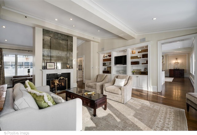 living room with a premium fireplace, crown molding, recessed lighting, and wood finished floors