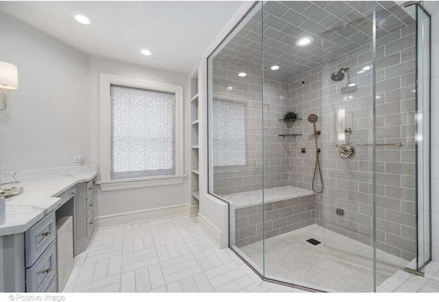 bathroom with a stall shower, baseboards, vanity, and recessed lighting
