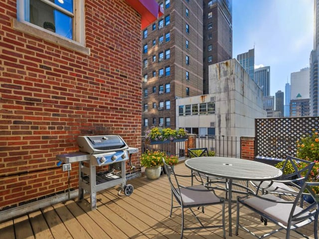 deck with grilling area and a view of city