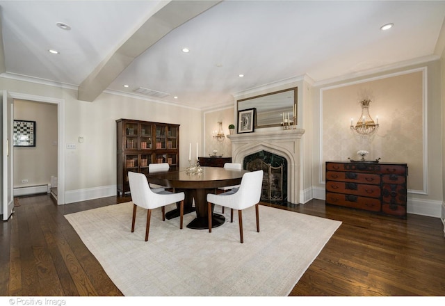 dining area featuring wood finished floors, visible vents, a fireplace, a baseboard radiator, and crown molding