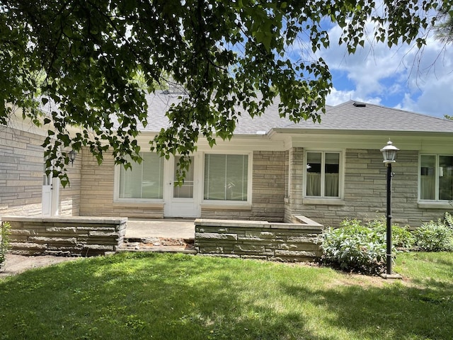 810 13th Ave, Mendota, IL 61342 - view of front of property featuring a front yard, a shingled roof, and stone siding