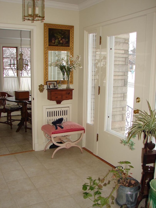 810 13th Ave, Mendota, IL 61342 - tiled entrance foyer featuring crown molding and a chandelier