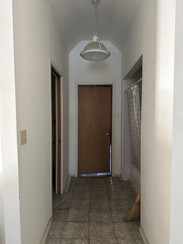hall with vaulted ceiling