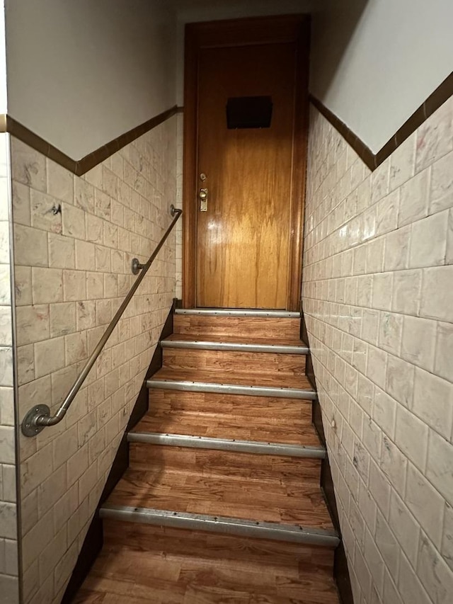 stairway featuring wood finished floors