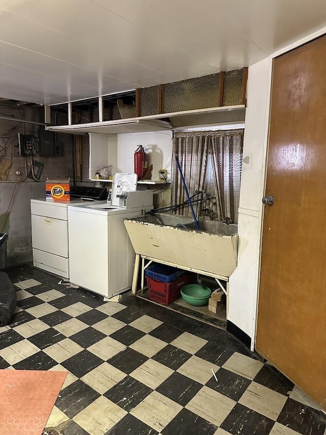 interior space featuring tile patterned floors, a sink, and washing machine and dryer