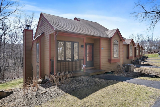 16 Oak Glen Dr, Galena, IL 61036 - chalet / cabin featuring a chimney, cooling unit, covered porch, and roof with shingles