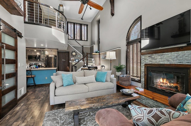16 Oak Glen Dr, Galena, IL 61036 - living area with stairs, a ceiling fan, a stone fireplace, dark wood-style floors, and visible vents
