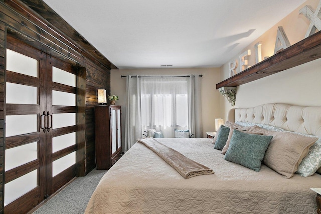 16 Oak Glen Dr, Galena, IL 61036 - bedroom featuring carpet flooring, visible vents, and wood walls