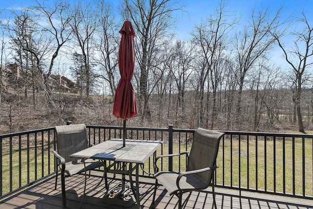 16 Oak Glen Dr, Galena, IL 61036 - wooden terrace featuring outdoor dining area, a view of trees, and a lawn