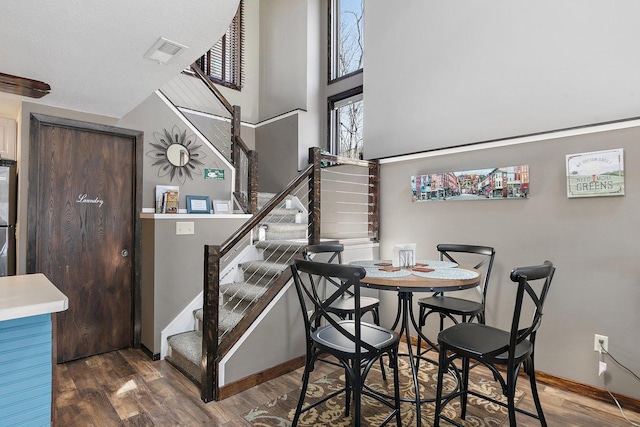 16 Oak Glen Dr, Galena, IL 61036 - dining area with stairs, visible vents, a high ceiling, and wood finished floors