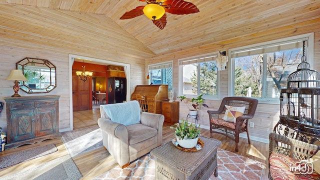 living room featuring wood finished floors, wood ceiling, ceiling fan with notable chandelier, high vaulted ceiling, and wooden walls