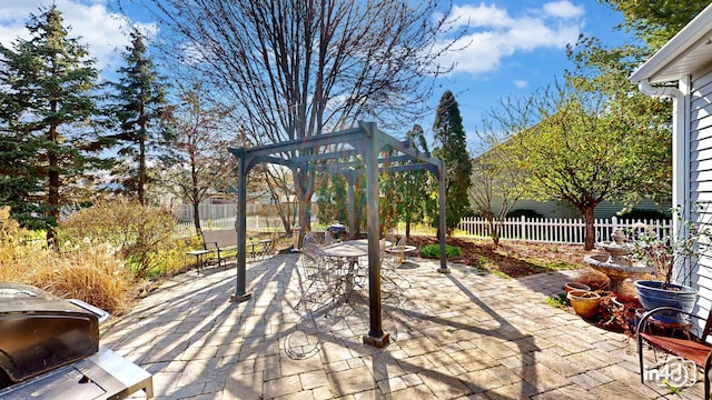 view of patio / terrace featuring fence, outdoor dining space, and a gazebo