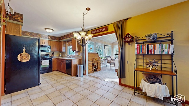 kitchen with a sink, a chandelier, light tile patterned floors, black appliances, and light countertops