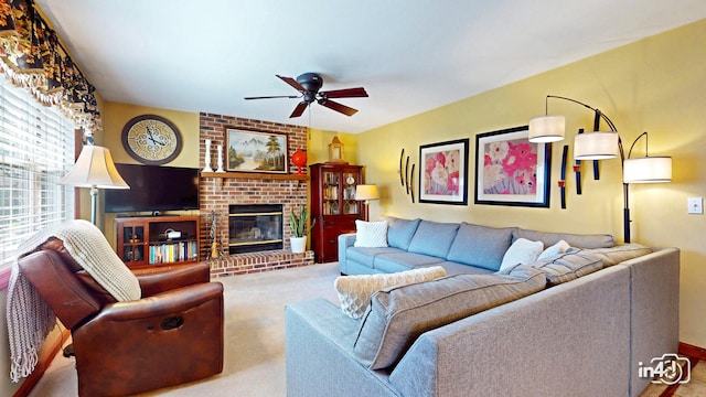 carpeted living area with ceiling fan and a brick fireplace