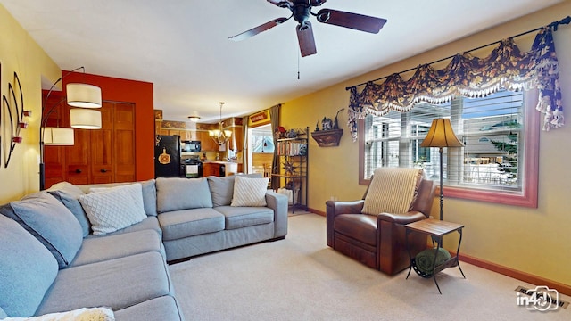 carpeted living room with a ceiling fan and baseboards